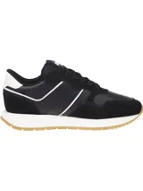 Zapatillas Tommy Jeans negras con detalles en blanco y suela color caramelo. Presentan paneles de cuero y gamuza, cordones negros y logo de la marca en el lateral.