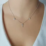Collar minimalista en plata 925 con tres dijes: una estrella, un corazón y una cruz, todos decorados con zirconia.