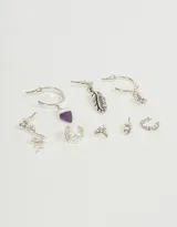 Set de seis aros de plata con diferentes dijes: serpiente, pluma, luna, estrella, cuerno de amatista y strass.