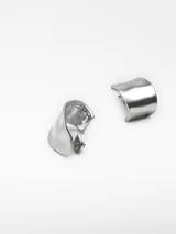 Par de aros metálicos plateados con diseño irregular y cierre de broche.