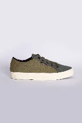 Zapatillas bajas color beige claro, con cordones y suela blanca.