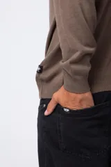 Sweater marrón de hilo con cuello alto tipo polera y mangas largas.