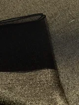 Bufanda rectangular color negro con trama brillosa y textura rígida.