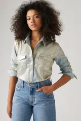 Camisa de manga larga con botones, confeccionada en tela brillante color celeste con efecto óptico. Tiene cuello clásico, dos bolsillos con solapa abotonada en el pecho y corte recto.