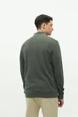 Buzo verde oscuro de felpa con medio cierre, cuello alto y logo de goma en el pecho.