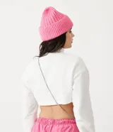Buzo cropped blanco de algodón con cuello alto y puños acanalados.
