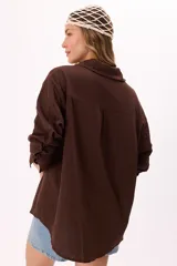 Camisa marrón de muselina, corte holgado, manga larga y botones al tono.