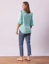 Blusa estampada color beige con cuello redondo calado y mangas 3/4 abullonadas con terminación elastizada.
