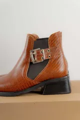 Botines Chelsea color beige con elásticos laterales negros, punta cuadrada, detalle de hebilla lateral y tacón bloque bajo.