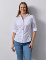 Camisa blanca de algodón marca Zac & Rachel, con cuello con solapa, escote en V, apertura central con botones metálicos, bolsillos delanteros, mangas 3/4 regulables y laterales en tejido modal.