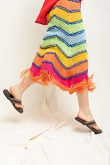 Pollera multicolor con diseño de rayas y flecos en el borde inferior.