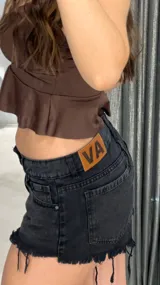 Short de jean negro con tiro bajo y terminación desflecada.