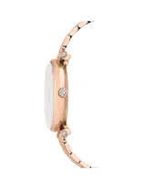 Reloj Swarovski Swiss Made, modelo Crystalline Wonder, con caja de acero inoxidable en tono oro rosa y esfera blanca plateada adornada con cristales. Brazalete metálico con acabado en tono oro rosa y números arábigos. Sumergible hasta 50m.