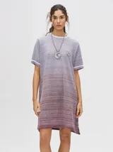 Vestido corto de tejido calado, con cuello redondo y mangas cortas con puños a rayas en color contrastante. Diseño con efecto degradado en tonos lila y borgoña.