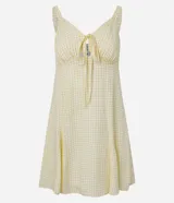 Vestido corto de corte evasé en color amarillo claro con estampado de cuadros. Posee escote en V, detalle de lazo central, fruncido bajo el busto y breteles finos regulables. Confeccionado en tejido de viscosa con forro de poliéster.