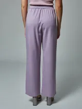 Pantalón negro de vestir, de corte recto y tiro alto, con pinzas en la cintura y bolsillos laterales.