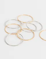Set de seis pulseras rígidas de metal, tres plateadas y tres doradas.