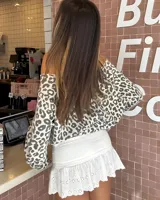 Minifalda blanca con short interno, cintura elastizada y volados con bordado inglés en el ruedo.