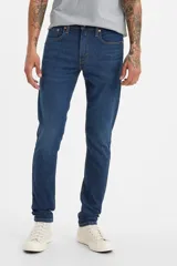 Pantalón de jean azul oscuro, corte skinny taper, con tiro medio y confeccionado en tejido stretch.