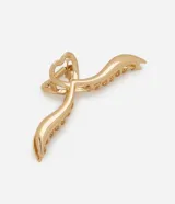 Pinza para el pelo dorada con forma de corazón infinito, hecha de metal reciclado.