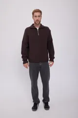 Sweater marrón de punto con cuello alto y cierre de cremallera metálica.