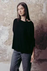 Remera negra de corte holgado, con cuello amplio y mangas 3/4.