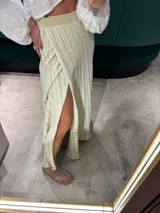 Falda midi color crudo con lurex, de corte evasé y abertura lateral.