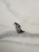 Dije de acero quirúrgico con forma de bota cowboy con detalles calados. Compatible con cadenas, cordones o tientos.