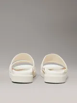 Sandalias planas Calvin Klein color blanco con doble tira ancha con logo jacquard en relieve.