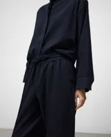 Pantalón de vestir azul marino con textura sutil, tiro alto y cintura elástica ajustable con cordón. Presenta pierna recta y nervio central en el frente.