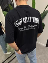 Remera negra de algodón con corte oversize y estampado en la espalda con la frase "Enjoy Great Times. Every day, Everywhere".