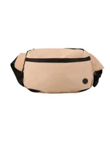 Riñonera o bolso cruzado unisex de lona color beige claro, con cierres negros visibles. Posee un bolsillo principal y un bolsillo trasero.