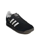 Championes Adidas SL 72 Rs negros con detalles en blanco y suela marrón. Zapatillas de running de estilo retro con las tres tiras clásicas de Adidas en los laterales y refuerzo de gamuza en la puntera y el talón.