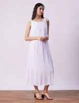 Vestido largo color mostaza de crepe, marca Marissa Olivia. Escote redondo con sobrecapa y detalle de crochet en los hombros. Corte en la cintura con punto smock. Sin mangas.