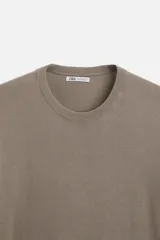 Camiseta negra de punto con cuello redondo, manga corta y corte regular. Tejido de viscosa con acabado en rib.