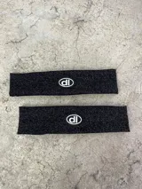 Vincha deportiva negra de lycra con logo blanco estampado.