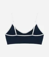 Soutien deportivo azul con breteles finos ajustables, base larga y detalles contrastantes en color blanco.