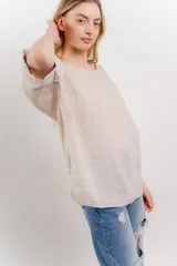 Blusa color beige confeccionada en lino, de corte holgado, mangas 3/4 y cuello redondo.