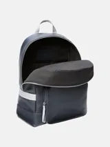 Mochila de piel sintética granulada color azul marino, con bolsillo frontal con cremallera y asa superior de tela gris. Presenta correas de hombro ajustables y el monograma "ck" en relieve en la parte inferior del bolsillo frontal.