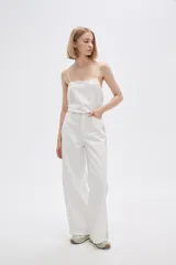Pantalón jean de calce ancho y tiro alto, con diseño color block en tonos blanco y beige.