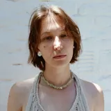 Aros tipo botón dorados con textura irregular que simula la superficie de un molusco.