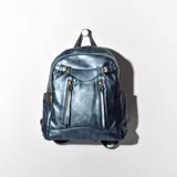 Mochila de simil cuero color azul eléctrico con detalles dorados y compartimentos.