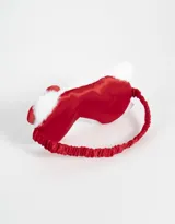 Antifaz de peluche blanco con la forma de la cara de Hello Kitty, con detalles bordados en negro y amarillo, moño rojo y elástico trasero.