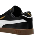 Championes Puma Club LI Era de cuero sintético negro con detalles en amarillo y suela color caramelo.