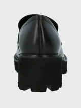 Mocasín de cuero color verde oliva con plataforma y suela de goma negra.