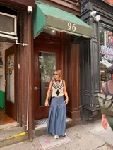 Falda larga de tela de jean con diseño de caderín y tablas.