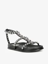 Sandalias negras con tiras de cuero sintético y tachas plateadas. Cierre con velcro en el tobillo.