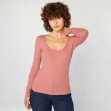 Camiseta de manga larga color rosa de canalé con cuello redondo.