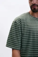 Remera verde con rayas horizontales blancas, de corte holgado y manga corta.