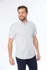 Camisa azul marino lisa de manga corta con cuello abotonado, cierre frontal con botones y bolsillo en el pecho. Confeccionada en algodón.
